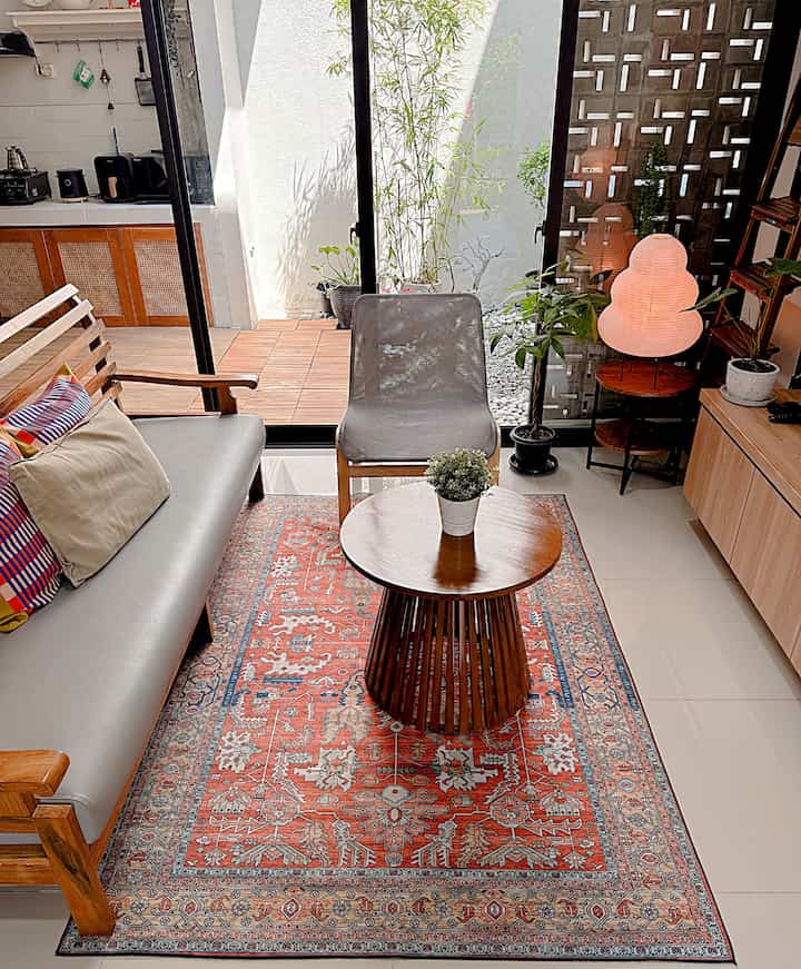 Natural color living room featuring wooden coffee table and armchair with cozy atmosphere