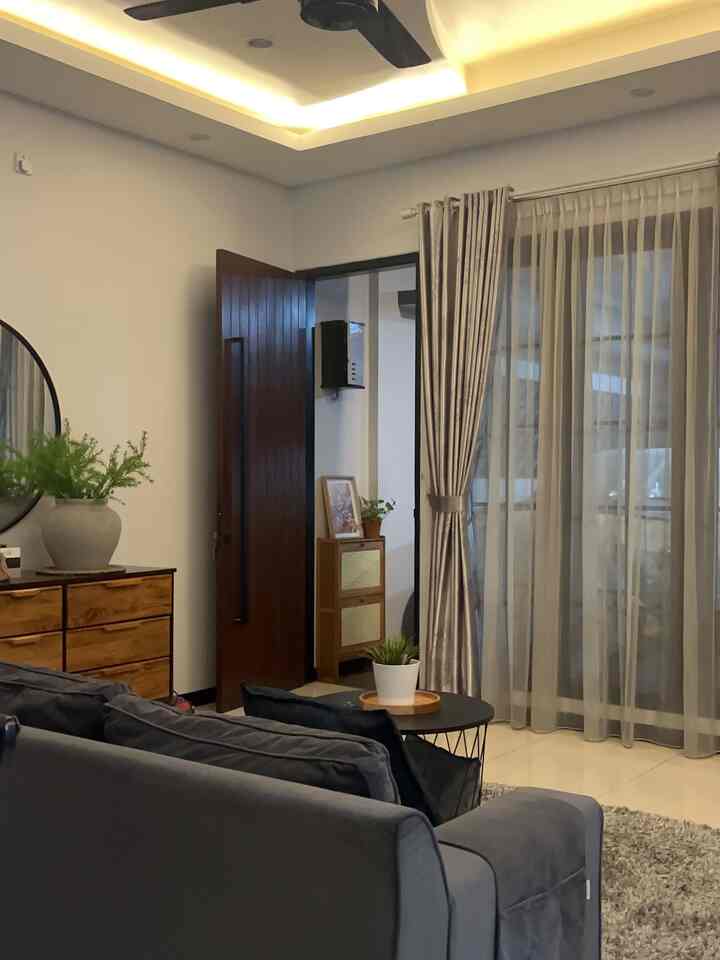 Grey and brown toned living room featuring a sofa and coffee table with a cozy atmosphere