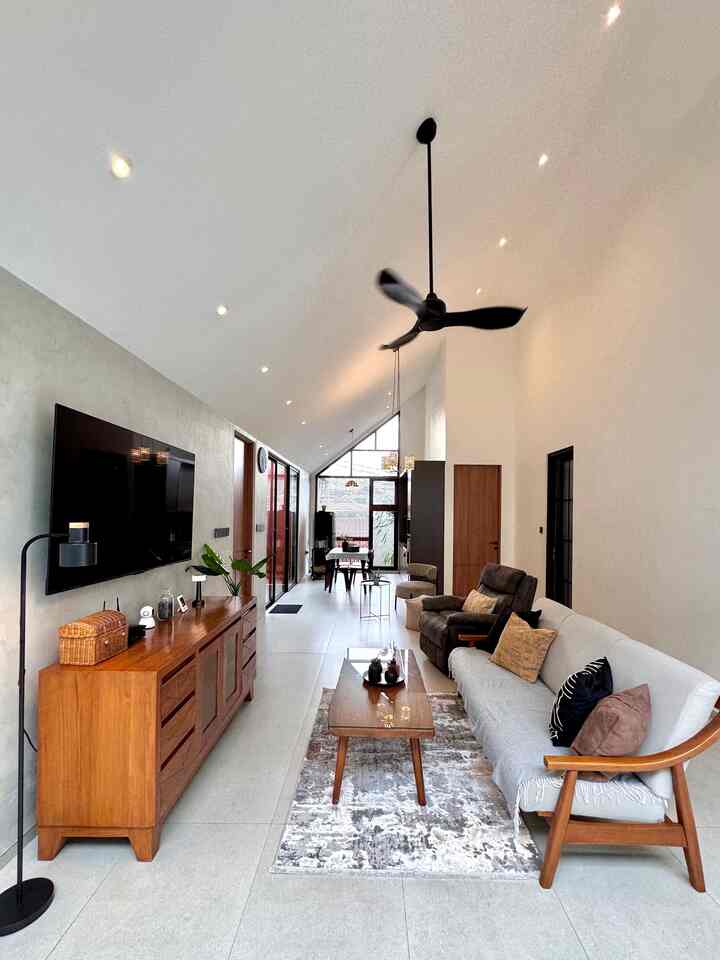 White and brown Nordic living room with sofa, armchair, and coffee table arranged in a natural modern space