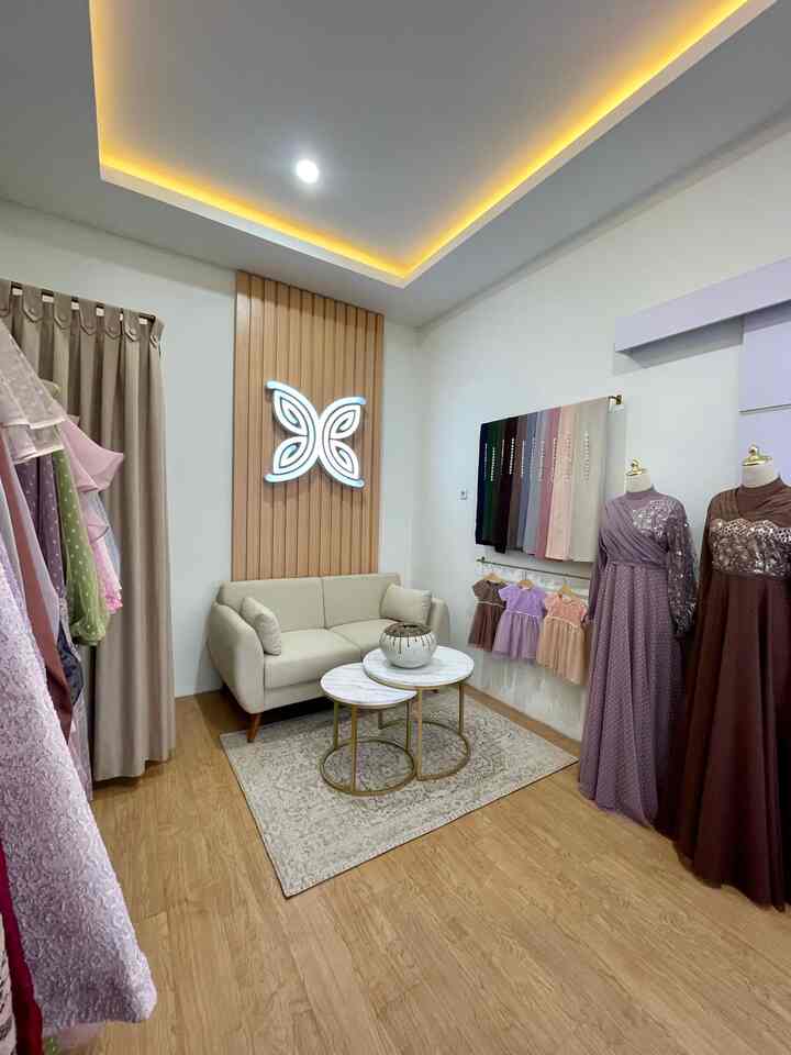 Cozy small living room with beige sofa, marble coffee tables, wood tone flooring and wall panel