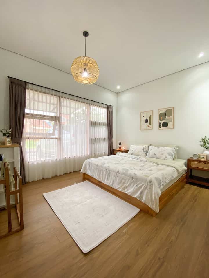 Natural and white tone bedroom featuring wooden bed and nightstands, bright and cozy atmosphere