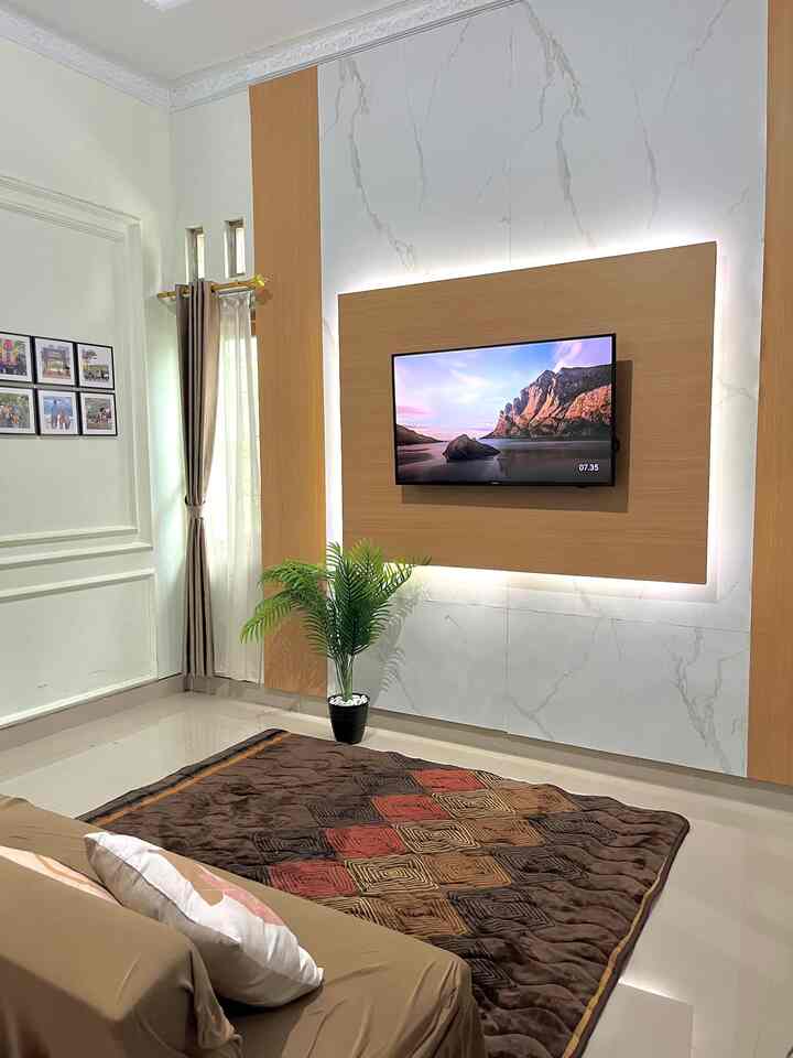 Natural-toned living room with sofa bed, carpet, and ambient lighting creating a cozy modern atmosphere