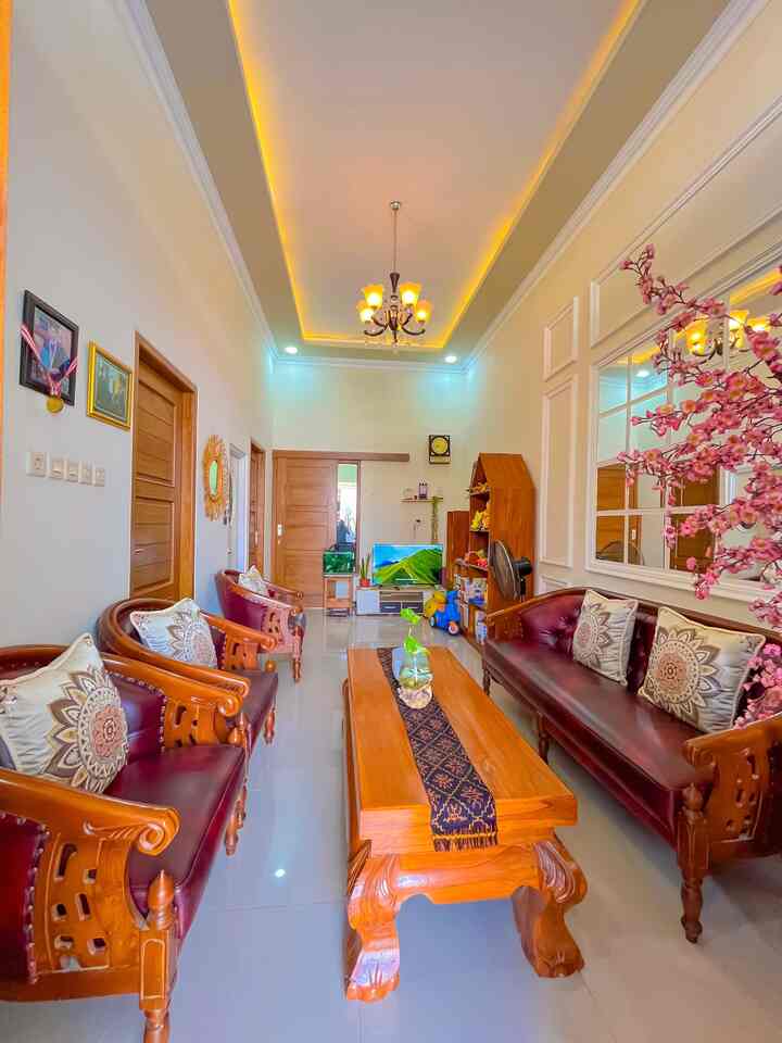 Natural color and wood tone living room featuring ethnic sofas and coffee table with warm inviting atmosphere