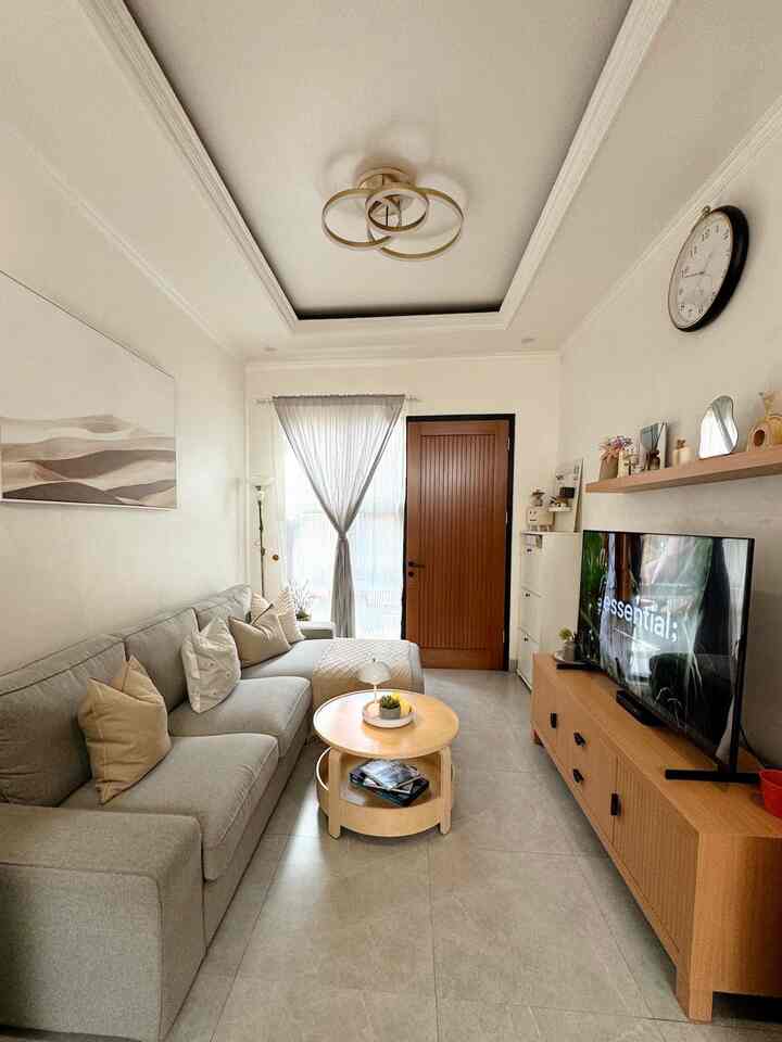 Natural color and white toned living room featuring a gray sofa and round coffee table with a cozy atmosphere
