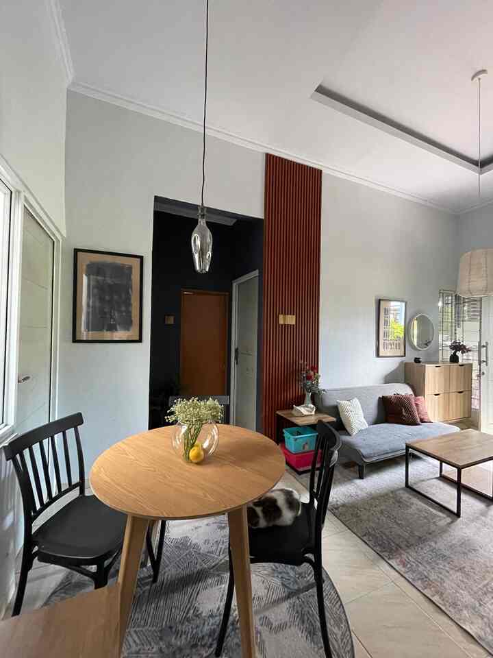 Natural color and wood tone two-person dining room with sofa, creating a cozy and compact living area