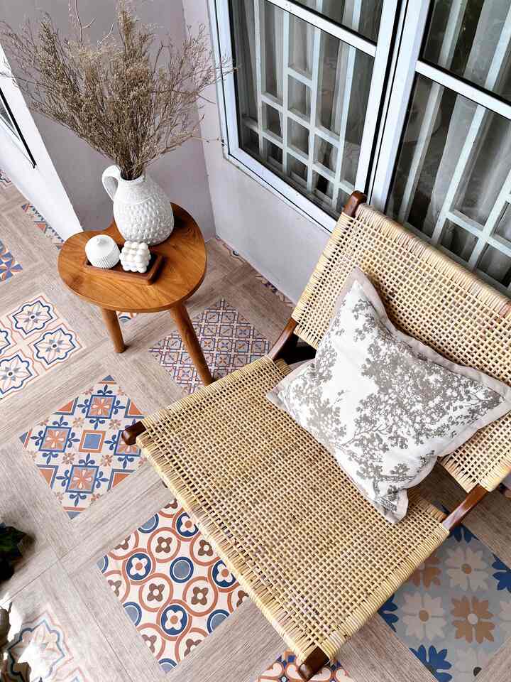 Natural tone balcony space featuring a wooden side table and rattan armchair with a cozy atmosphere
