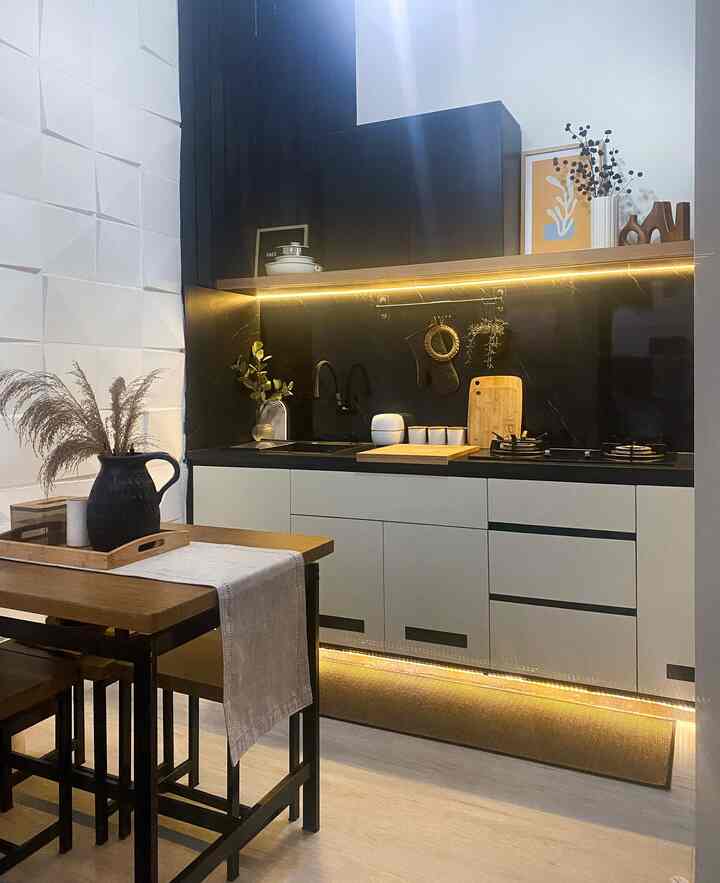 Monotone black and white kitchen featuring wood-tone dining table and stools with a clean, modern atmosphere