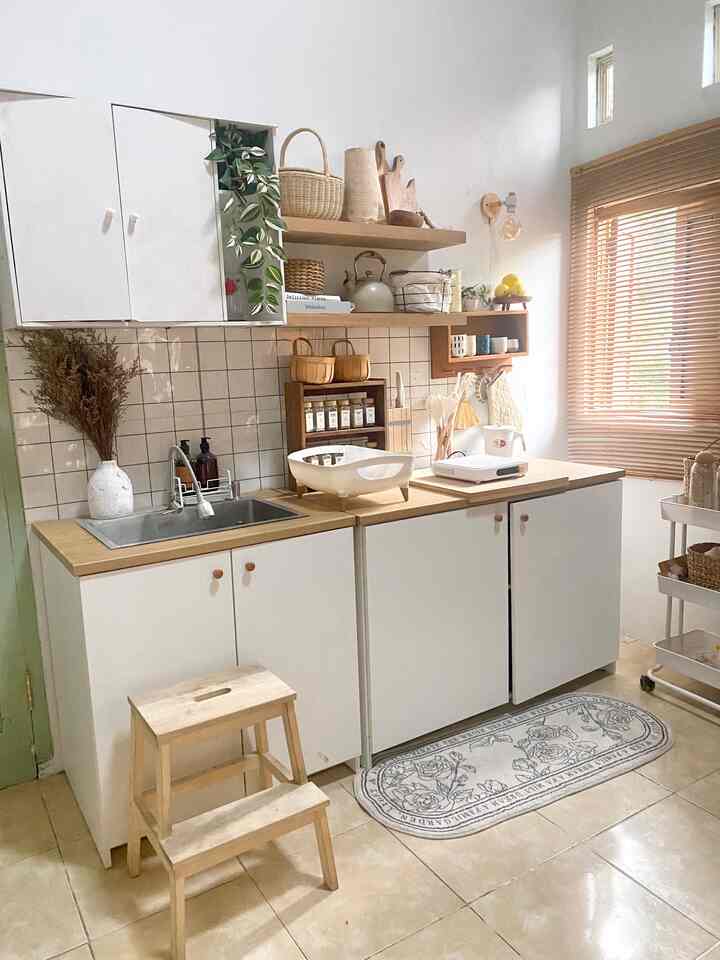 Compact kitchen space featuring white and wood tones, with smart storage ideas and a cozy atmosphere
