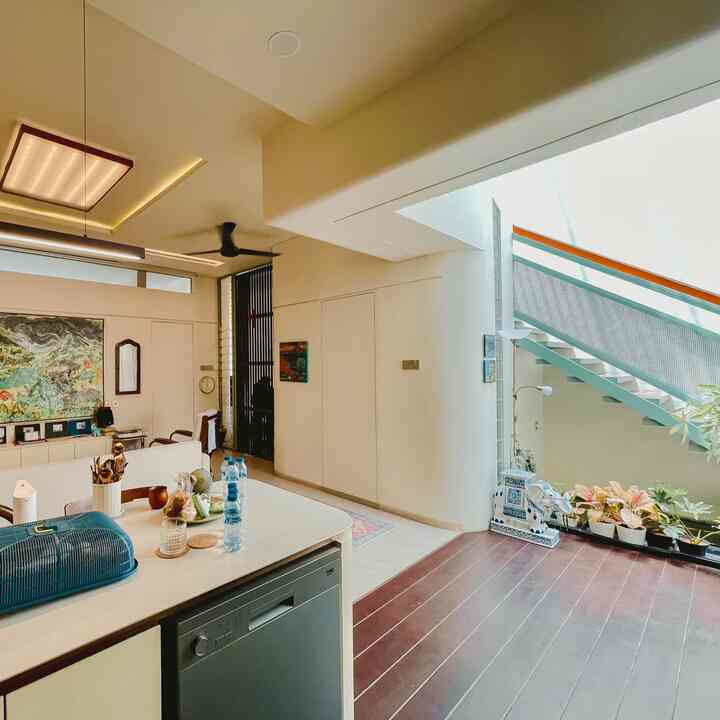 The SFhaus floorplan is designed with an open space ‘terrace house’ concept as is typical in Malaysia and Australia. The first floorplan proposed by our architect was rejected, so the second floorplan was designed to be bolder, more experimental, unorthodox, and idealistic with a KDH of 56%. This layout was created because the house was designed ‘function follows form’. This design is definitely not for everyone and we are unapologetic about it. 

SFhaus includes tropical features of colonial jengki houses that are very rarely found because they seem old-fashioned. The approach is tropical bioclimatic. 

Living, kitchen, and inner court are connected into one to the backyard dining, with an unbroken circulation flow to the 2nd floor. The main point of this house is in the 7 m high ventilated inner court which functions as a connecting point between spaces, making it easy to call each other. 

The challenge of an open space house is privacy. So, the architect arranged for there to be personal space zoning. In our opinion, a house that is too open is uncomfortable, just like a studio apartment that has been enlarged, there is no spatial experience. Architects arrange for privacy to be maintained from outsiders even when all windows are opened. Common challenges such as mice, insects, noise, etc. are already prevented. Of course, a house with many openings means a lot of dust. 

What surprises guests who come is that our house is cool and breezy during the day, and there are few mosquitoes at night. 

The advantages of an open space house with a bioclimatic concept are: 
- Energy efficient. Electricity costs around IDR 900,000 per month. 
- The daytime temperature from 12-2 is maintained at around 28° (during the rainy season like now it can drop 2-3°) with a relative humidity of 50-55% via a digital hygrometer. Most houses with many openings still feel stuffy, hot, comfortable with AC, and lots of mosquitoes because they do not detail the principles of bioclimatic physics. 
- Ergonomic layout. The house follows the habit, not the habit follows the house. 
- Breezy, cool, not humid in all areas
- Bright but not roasting during the day
- Few mosquitoes

#OpenSpaceHouse #RumahTanpaSekat #RumahLega #Ruglivingroom #Karpetkotak #furniturantik #ConsoleTable #midcenturymodern