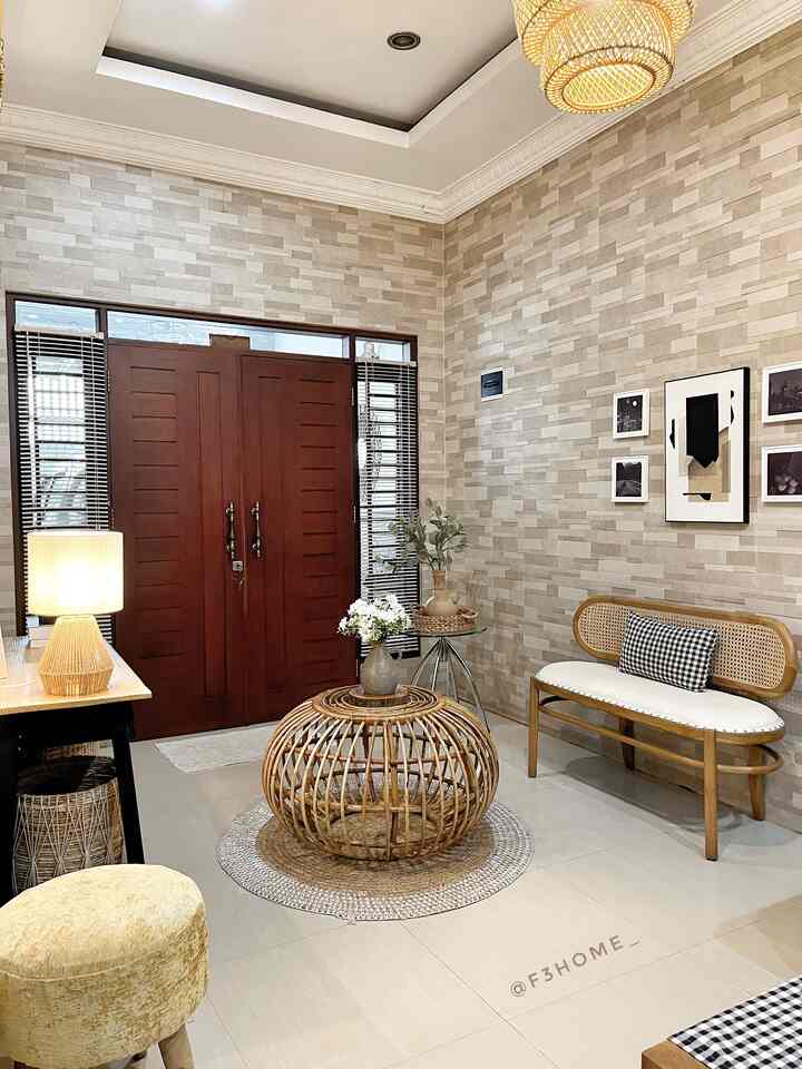 Living room in natural beige tones featuring wooden bench and rattan coffee table with cozy atmosphere
