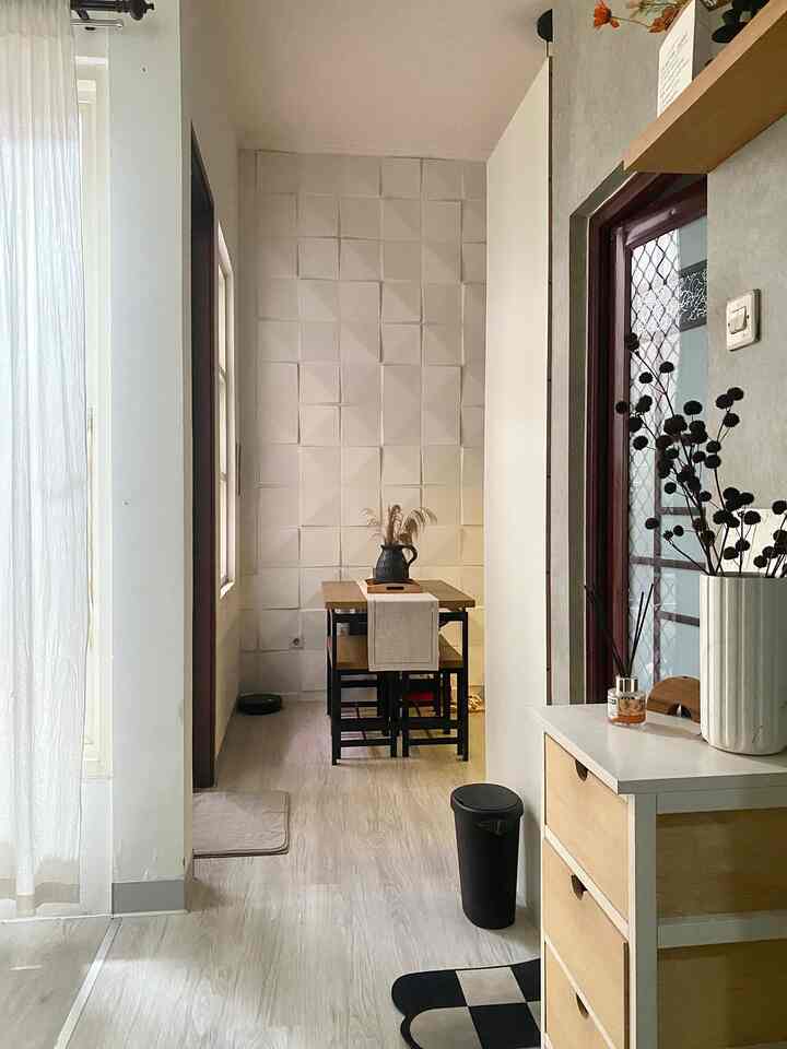 Natural color toned narrow dining room featuring modern table and chairs with a cozy atmosphere