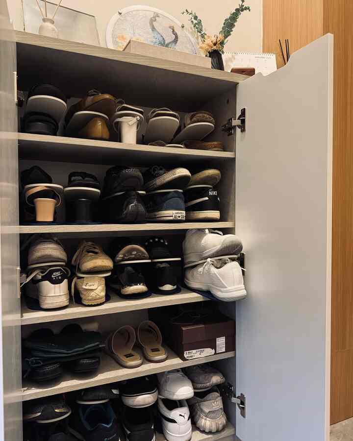 White shoe cabinet in a compact space efficiently organizing numerous shoes in a neat storage area
