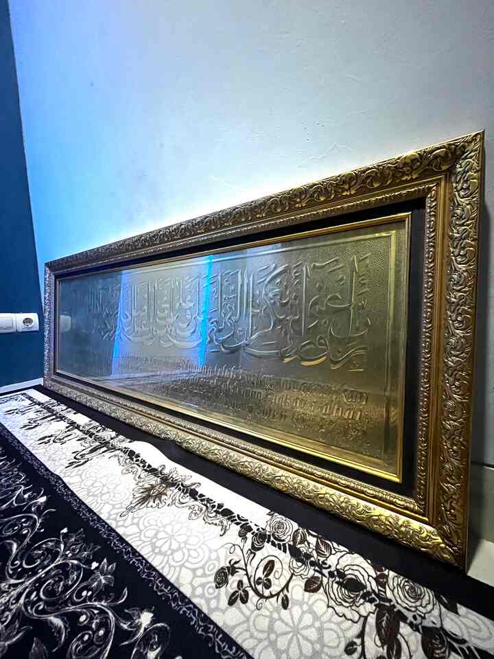 Decorative space with a gold picture frame beside a blue wall and traditional patterned carpet