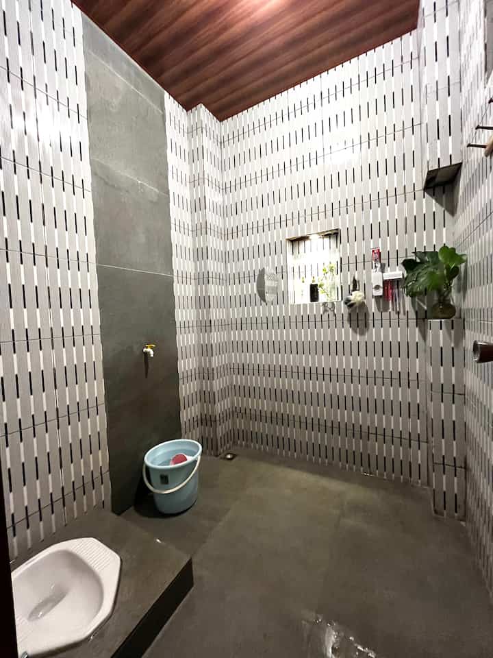 This bathroom is 2 x 1.8 m in size, as native Indonesians we still use a squat toilet because this bathroom is located in the middle of the house, where it can be accessed by anyone. 
The material is a combination of granite and ceramics which are installed up to the top and the roof we install a PVC ceiling with the aim of being resistant to humidity. 
As "plant lovers" we also added plants in the corner of the room. 

#bathroomrenovation
#bathroommakeover
#bathroominspiration
#bathroomgranite
#bathroomceramics
#squattowel
#indonesianbathroom
#classicbathroom
#plantlovers
#pvcceiling
#bathroomceiling
#romangranite

