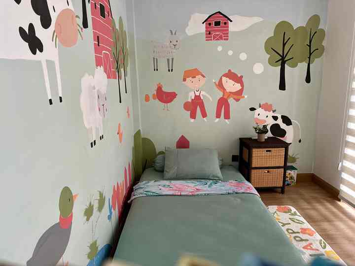 Natural-toned kids' room featuring animal and child wall murals with a cozy bedroom atmosphere