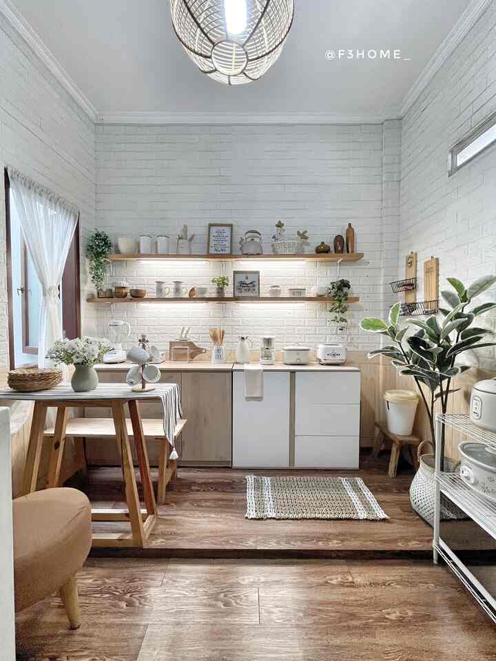 Bright white brick walls and wood tone furniture create a cozy kitchen space with natural and clean ambiance