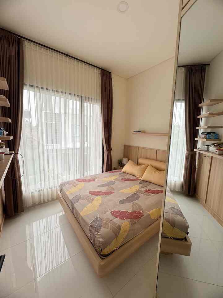 Natural-toned bedroom featuring patterned bedding and brown curtains in a clean, modern space
