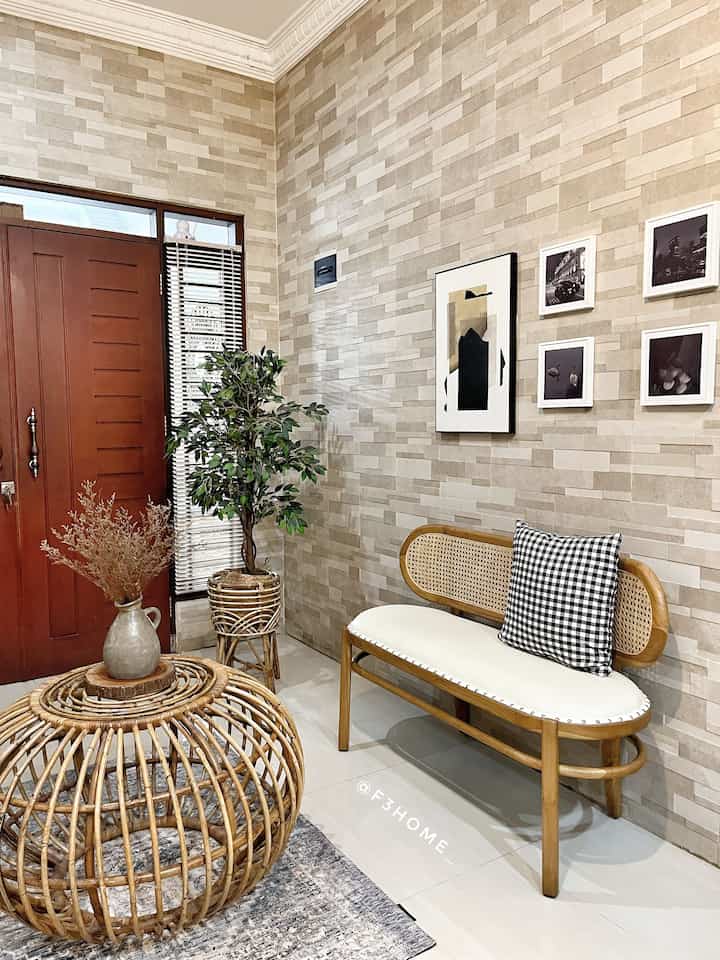 Beige-toned walls and rattan furniture in an entrance area, creating a cozy and natural atmosphere