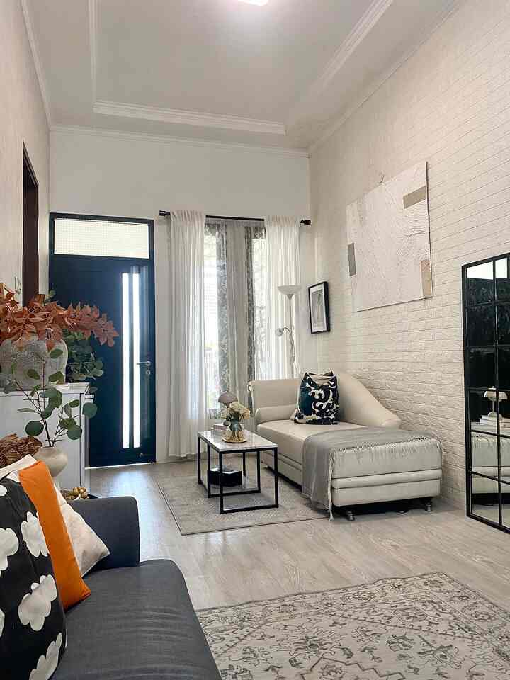 Bright white and gray toned modern living room featuring two sofas and carpets in a cozy space
