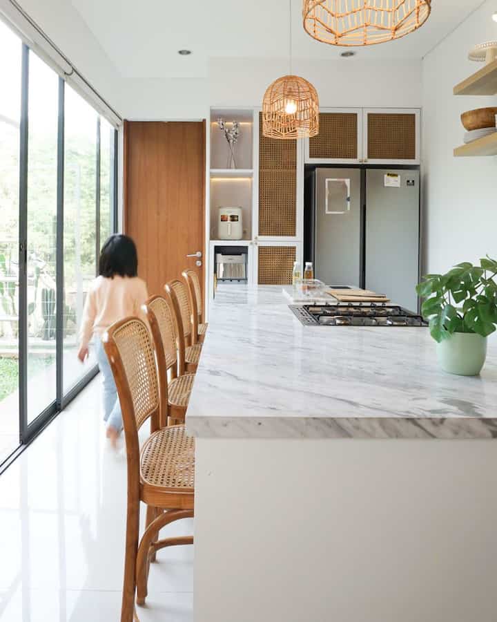 Expectation vs. Reality: Building My Dream Kitchen

This white kitchen has been in my dreams for a long time. Finally, it came true at the end of 2021—two years after we moved into this house. In addition to having to prepare a budget, I was also quite selective in choosing a designer and contractor. After much consideration, the choice fell on Hyde Living.

The cost of designing and building this kitchen was around 50 million rupiah, not including kitchen appliances and additional accessories such as IKEA shelves, knobs, and small plant decorations that beautify the room.

In slides 2 and 3, you can see a comparison between the rendering image and the actual result. It turns out, it's very similar! The only difference is that we decided not to install a cooker hood because the roof was already tightly closed and did not allow for ducting.

Now, cooking is more fun! This kitchen is not only beautiful to look at, but also very functional.

Do you think it's worth spending that much for your dream kitchen?

#DreamKitchen #DreamKitchen #OpenKitchen #KitchenIsland #MarbleCountertop #KursiBar #LampuRotan #KomporFreestanding #TanamanArtifisial #NordicHome #TheABChaven
