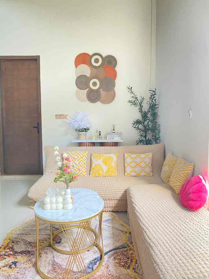 Beige-toned living room featuring beige sofas and yellow cushions in a cozy cafe-style setting