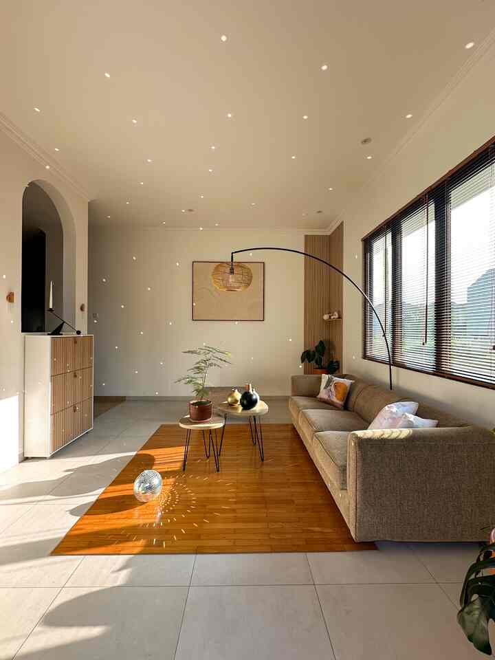 Warm brown and wood tone living room featuring sofa and floor lamp with cozy atmosphere