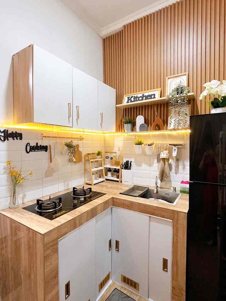Compact kitchen with white and natural wood tones, cozy lighting and neat storage ideas creating a warm atmosphere
