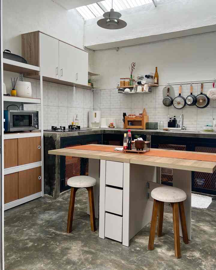 White and brown toned compact kitchen featuring a dining table with stools and practical storage units