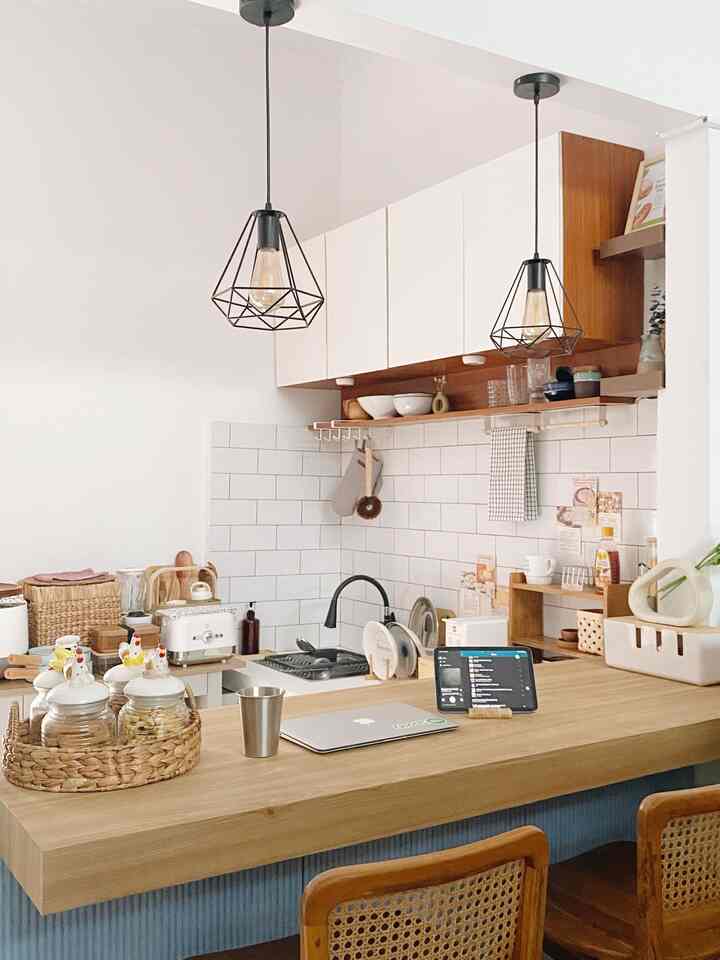 Natural wood tone and white kitchen featuring pendant lights and a cozy home cafe atmosphere