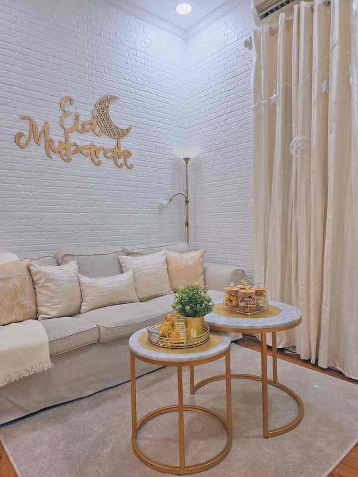 Beige and white toned living room featuring a beige sofa and gold-accented coffee tables in a natural modern style