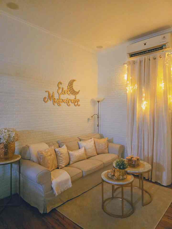 Warm beige and gold toned living room featuring a beige sofa and gold accents, creating a cozy atmosphere.