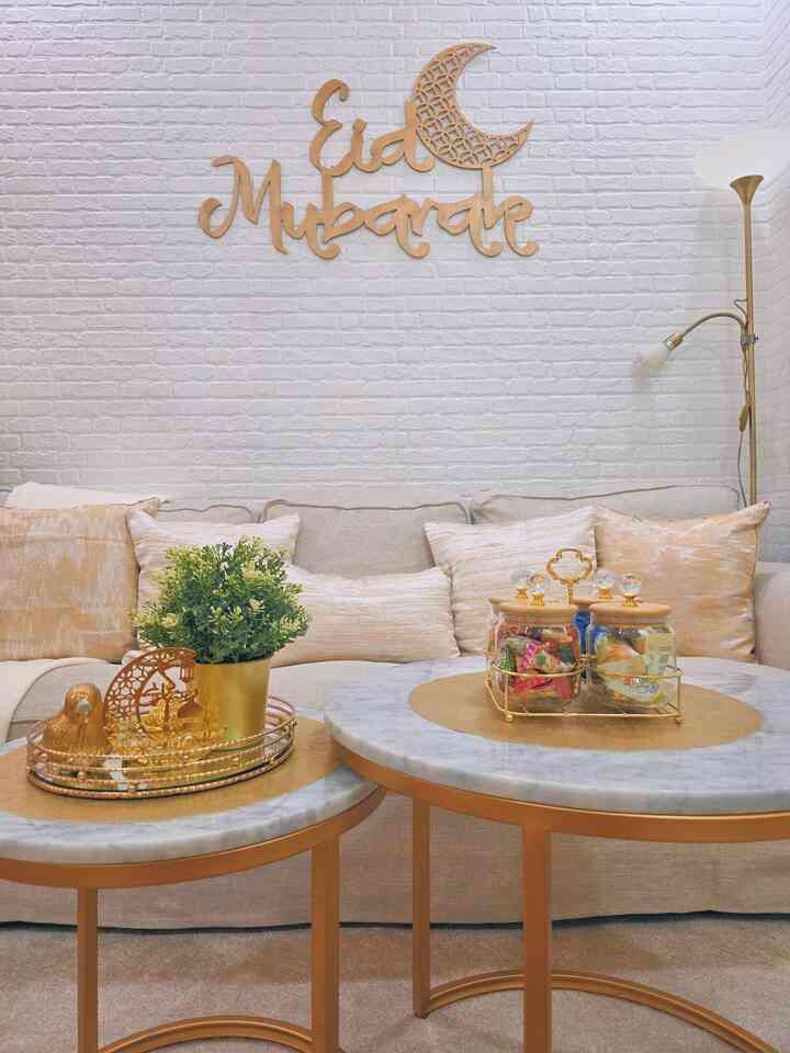 Cozy living room with beige sofa and gold-toned coffee tables accented by decorative elements