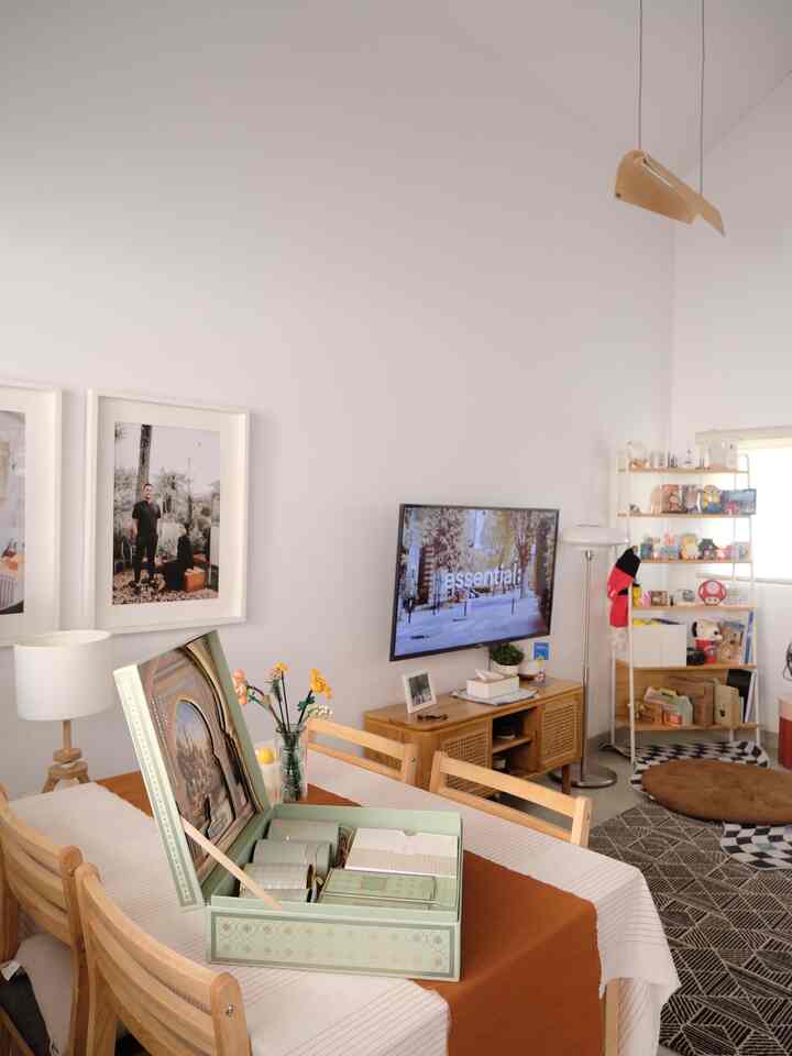 Natural brown wood dining room with white walls, featuring a table runner and wall decor creating a warm atmosphere