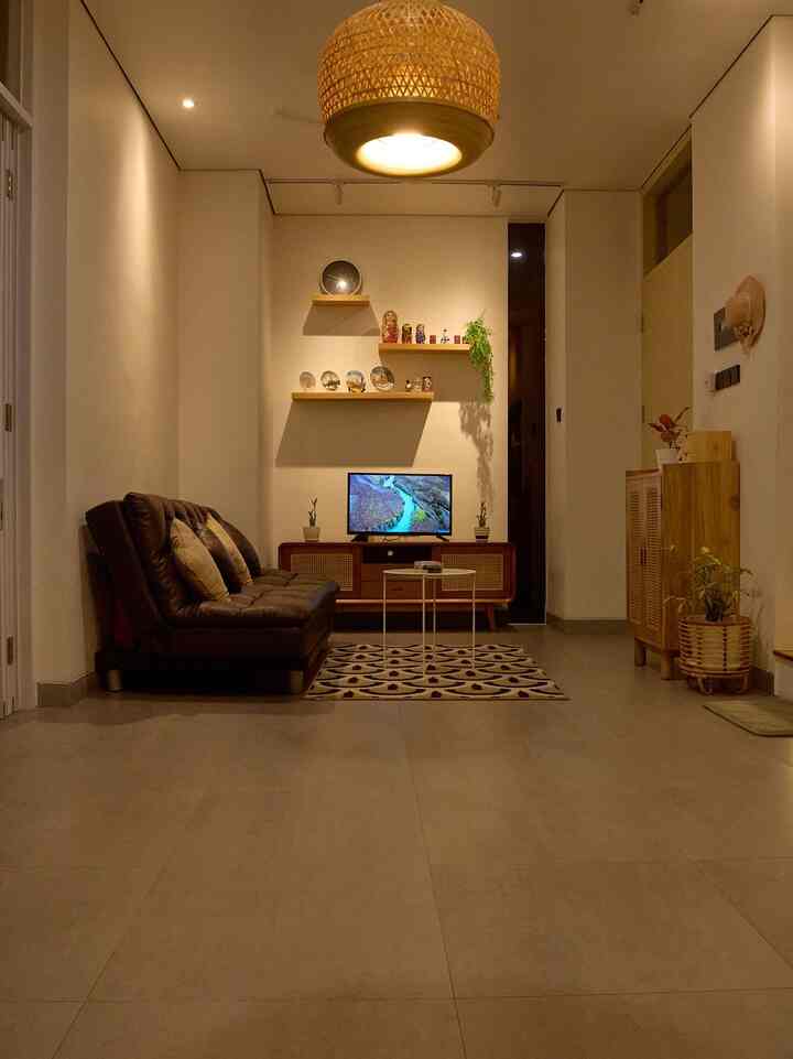 Desain open space di rumah kecil ini makin terasa hangat dengan pencahayaan kuning temaram dan elemen kayu yang mendominasi. Sofa kulit jadi andalan sih, tapi biar nggak bosen, aku suka banget muter-muter posisinya tiap beberapa minggu. Kadang geser ke tembok, kadang jadi pembatas sama meja makan, pokoknya biar suasana rumah selalu terasa baru.

Mood lamp, rak dinding, dan karpet motif retro jadi pelengkap vibe malam yang tenang dan nyaman.

#SofaMinimalis #KarpetEstetik #AmbalanDinding #LampuRotan #MejaTVRetro
#RumahOpenSpace #RumahTanpaSekat #NightVibe