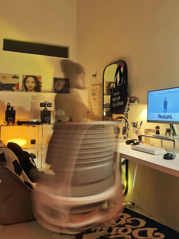White and black toned compact home office space featuring an office chair and desk with a practical, cozy atmosphere