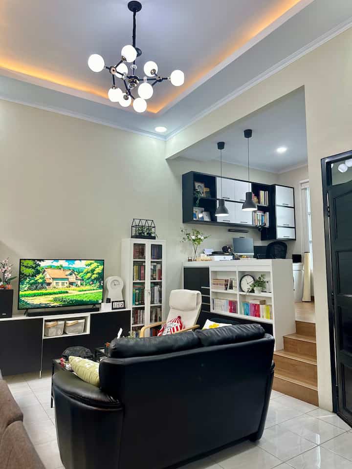 White and black wood tone living room and home office space featuring clean open plan layout