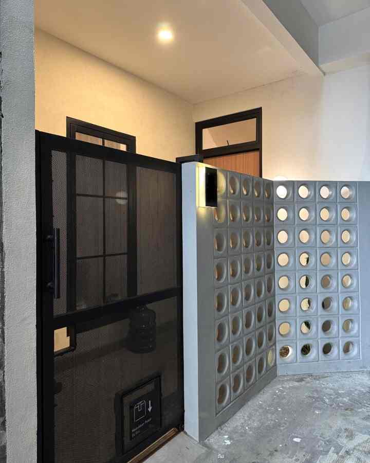 Setelah berbagai pertimbangan, kami merasa desain fasad ini paling cocok untuk rumah kami di gang kecil. Kami butuh ruang yang tetap terasa lega dengan pandangan luas, tapi tetap menjaga privasi. Akhirnya, pilihan jatuh pada penggunaan roster beton bulat berukuran besar dan pagar besi perforated yang berpori agar kami masih bisa melihat area luar rumah, namun keamanan tetap terjaga. Untuk menambah sentuhan retro, pilihan jatuh kepada roster berbentuk bulat. Setiap rumah punya caranya sendiri buat “tampil”. Kalau kamu, tim roster, kisi-kisi, atau dinding polos??
#inspirasifasad #stylefasad #fasadrumah #roster #pagarbesi