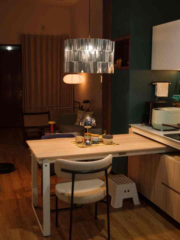 Warm wood tone kitchen and dining area featuring a dining table with two chairs, creating a cozy two-person household vibe