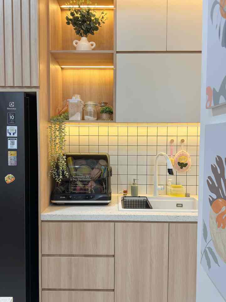 Simple modern kitchen with white tiled backsplash and wood tone cabinetry creating warm, clean atmosphere