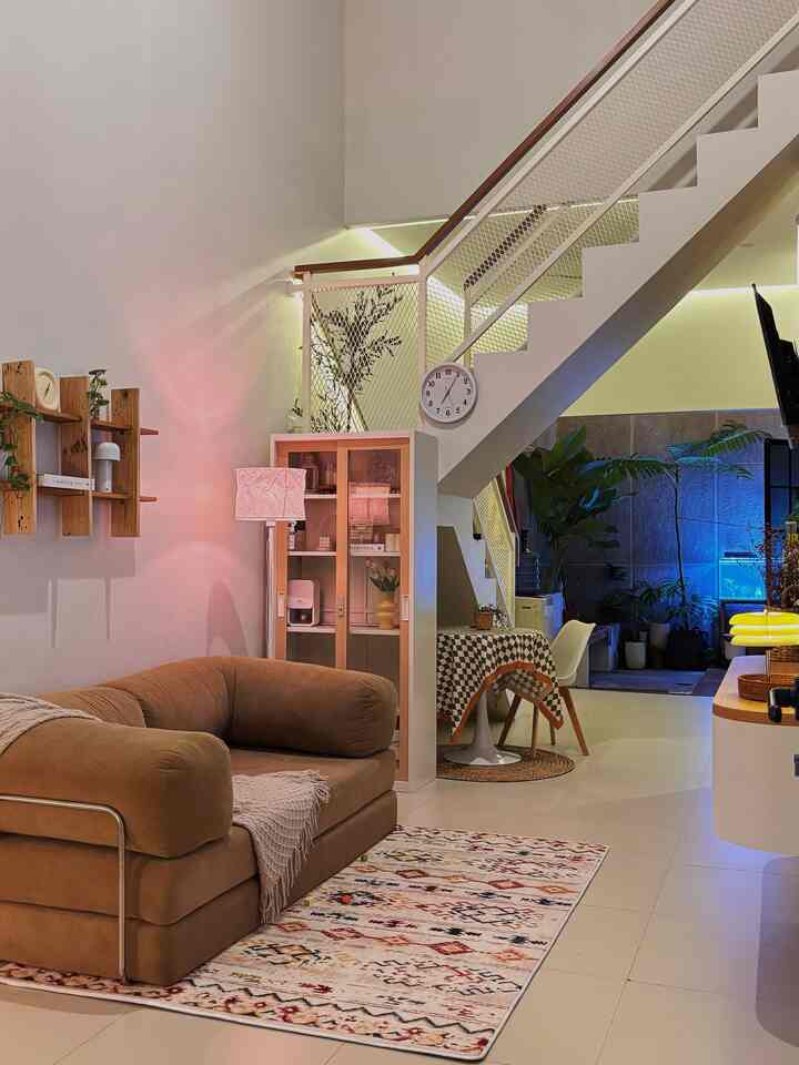 Natural-toned living room featuring brown sofa bed and patterned carpet with a modern, cozy atmosphere