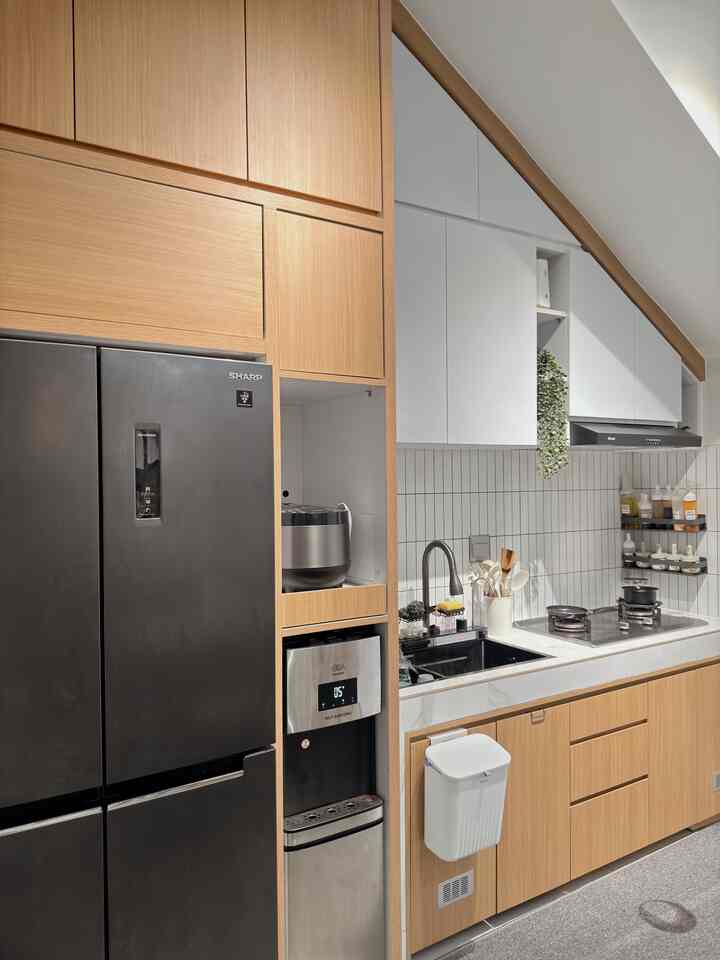 Modern kitchen featuring white tiled backsplash and wood tone cabinetry creating a sleek atmosphere