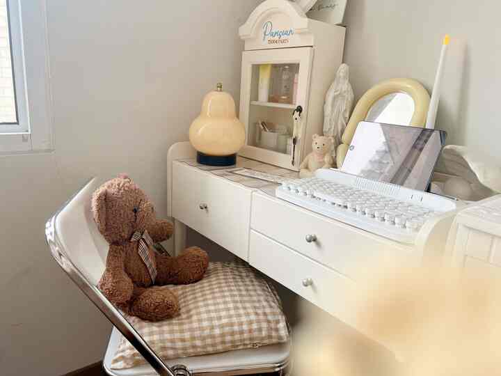 White and beige toned home office space featuring a desk and office chair with a cozy, minimal atmosphere
