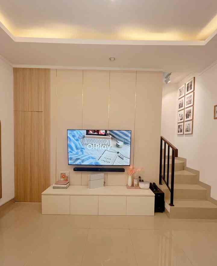 White and natural color living room featuring a centrally placed TV with a simple storage unit