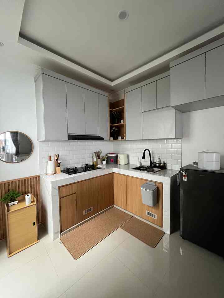 White and wood tone kitchen space featuring clean storage and functional cabinetry in a minimal modern style