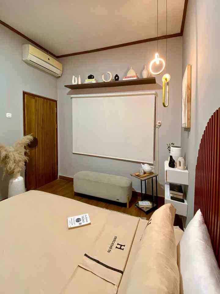 Beige and wood-tone bedroom featuring modern furniture and warm lighting, creating a cozy atmosphere