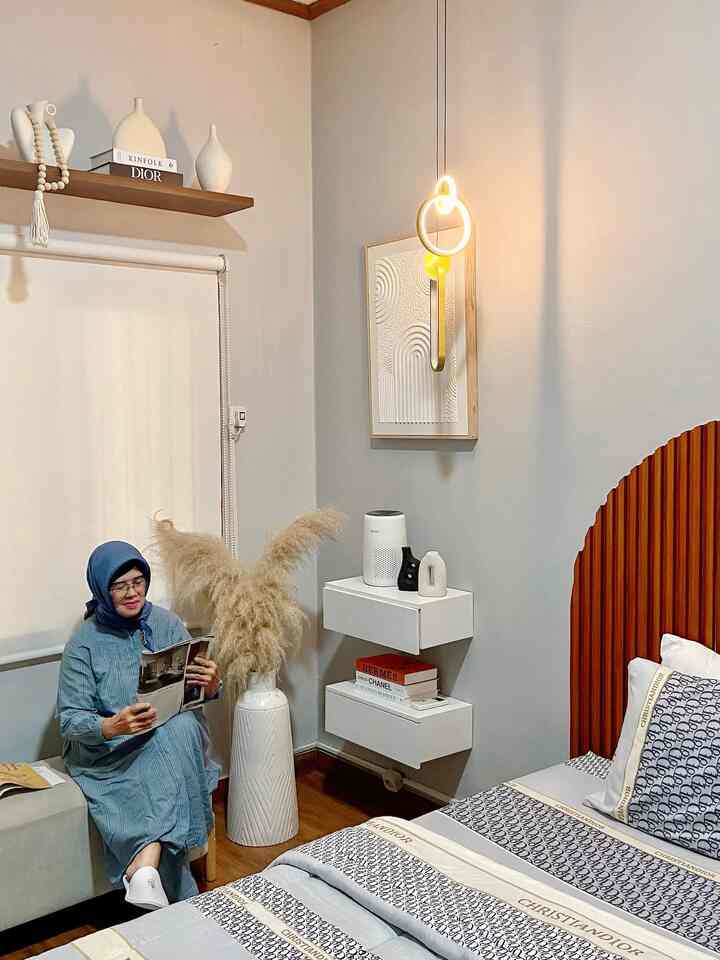 Light gray and white toned bedroom featuring wood-toned bed and natural material decor creating a cozy atmosphere