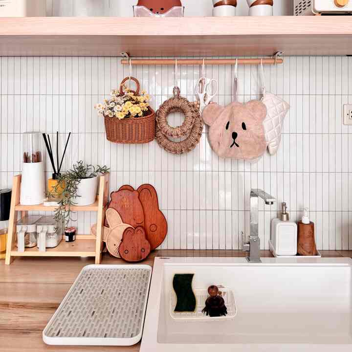 Natural color-toned kitchen featuring wooden cutting boards and utensils on a tidy countertop with warm, organized atmosphere