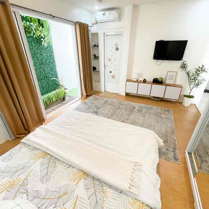 White and brown toned 6-tatami bedroom featuring bed, TV stand, curtains, and plants in a neat interior