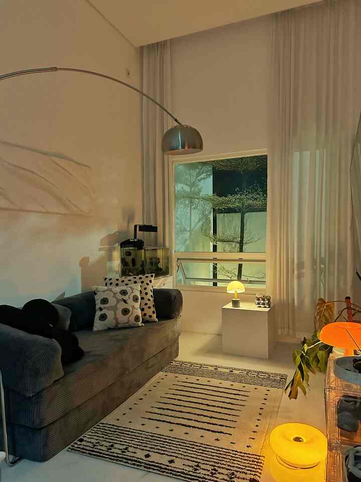 Ivory and gray toned living room featuring a bohemian pattern carpet and corduroy sofa with a cozy natural atmosphere