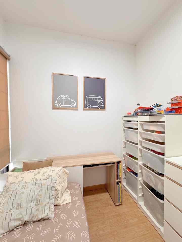 A white and natural-colored bedroom featuring a sofa bed and large storage cabinet in a tidy arrangement
